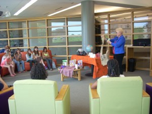 Jeannie holds a laptop bag made from a recycled feed sack.
